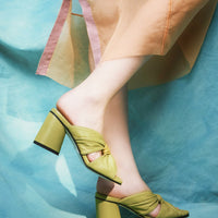 Fleur Green Leather Heel Mules, styled with a sheer peach-toned dress - POEVE Collection