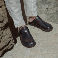 Osaka Black Leather Mules with Metal Buckle, styled with light linen trousers - POEVE Collection