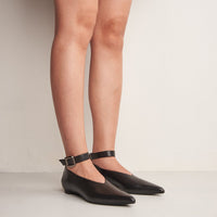 Stevie Black Leather Flat Shoes with Metal Buckle, worn on bare legs - POEVE Collection