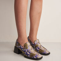 Noemi Snake-embossed Leather Heel Loafers, worn on bare legs - POEVE Collection