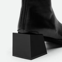 Nora Black Leather Heel Ankle Boots with Metal Detail - Heel Close-up View - POEVE Collection
