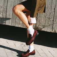 Dannie Bordeaux Hairy Leather Loafers paired with white socks and a tailored olive green blazer - Side View - POEVE Collection