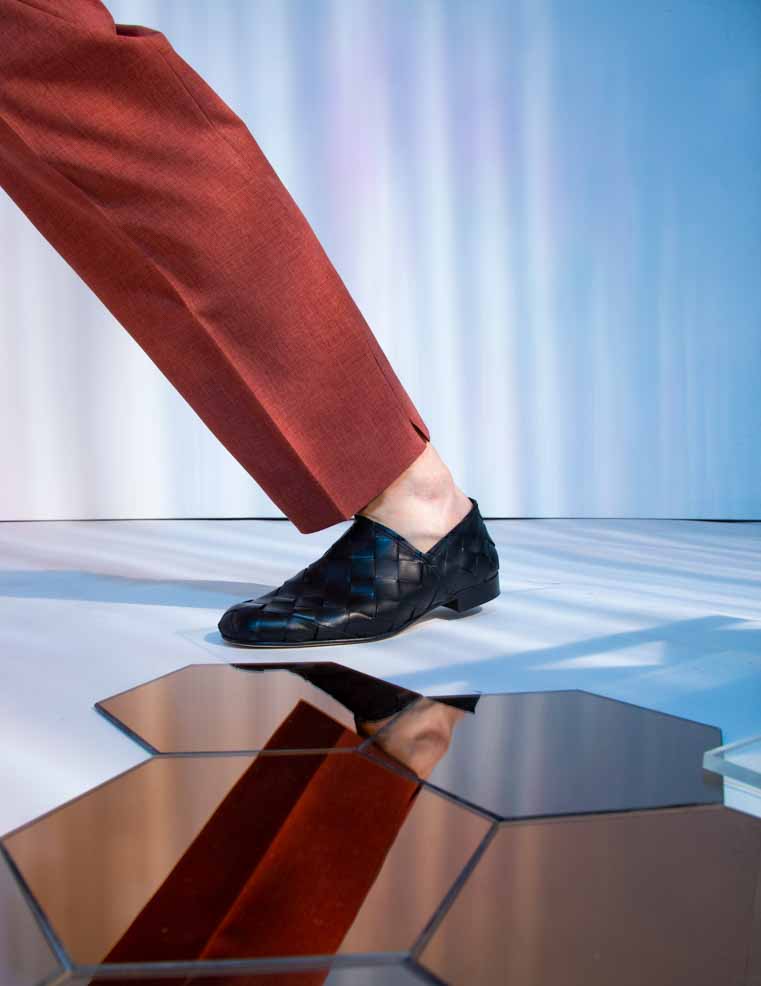 Sand Black Hand-Woven Leather Loafers, styled with rust-coloured trousers - POEVE Collection