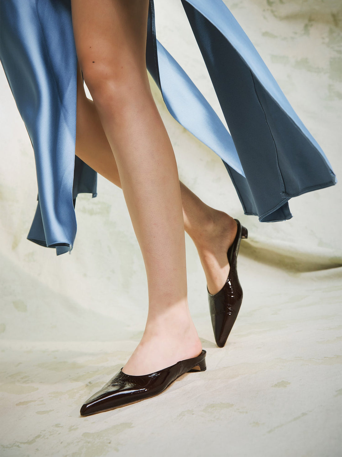 Faye Brown Crinkled Patent Leather Mules, , styled with a flowing blue dress - POEVE Collection