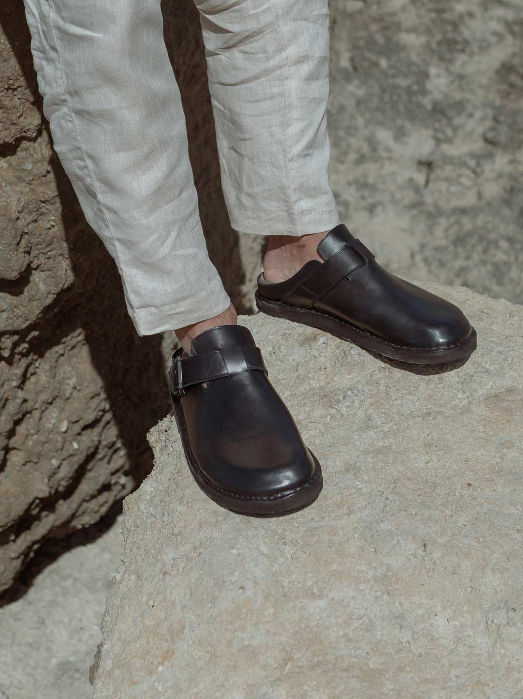 Osaka Black Leather Mules with Metal Buckle, styled with light linen trousers - POEVE Collection
