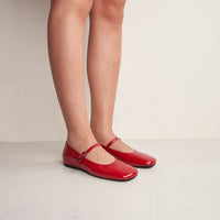 Aurora Red Crinkled Patent Leather Ballerinas, worn on bare legs - POEVE Collection