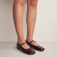 Aurora Dark Brown Crinkled Patent Leather Ballerinas, worn on bare legs - POEVE Collection