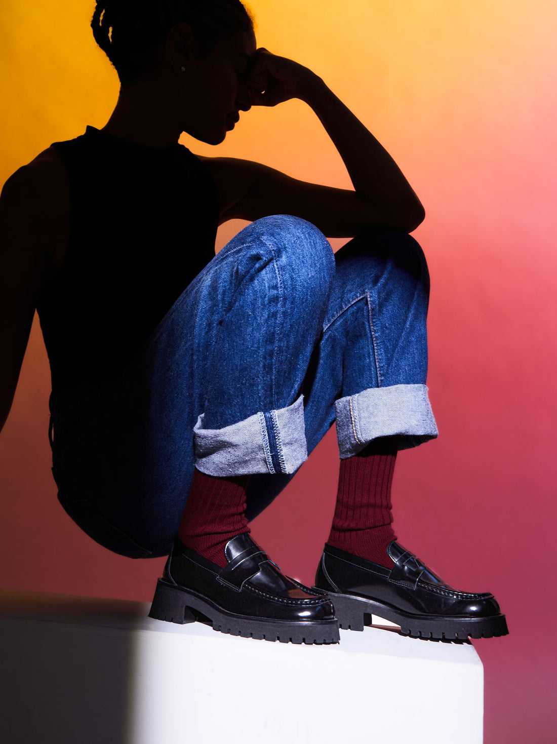 Emil Black Brushed Leather Loafers, styled with burgundy ribbed socks and cuffed denim jeans - POEVE Collection