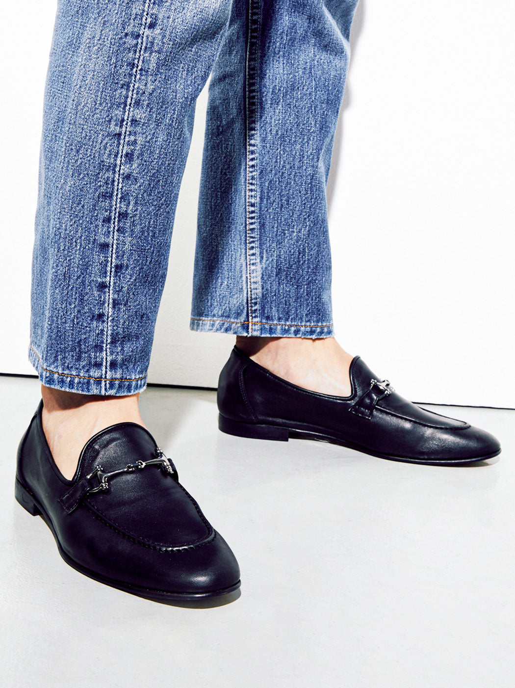 Harry Black Leather Loafers with Metal Buckle, styled with cropped straight-leg denim - POEVE Collection