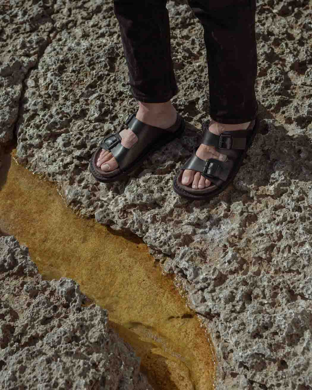 Rory Black Leather Mules with Metal Buckles, styled with black denim pants - POEVE Collection