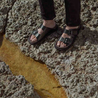 Rory Black Leather Mules with Metal Buckles, styled with black denim pants - POEVE Collection