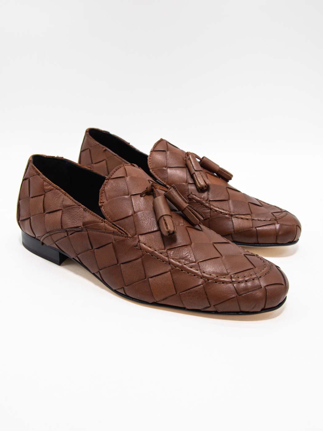 Aidan Cognac Woven Leather Loafers with Leather Tassel - Three-Quarters View - POEVE Collection
