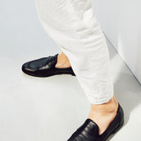 Oscar Black Leather Penny Loafers, styled with white linen trousers - POEVE Collection