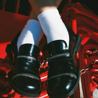 Ayko Black Brushed Leather Loafers with Metal Zipper, worn with white socks - POEVE Collection