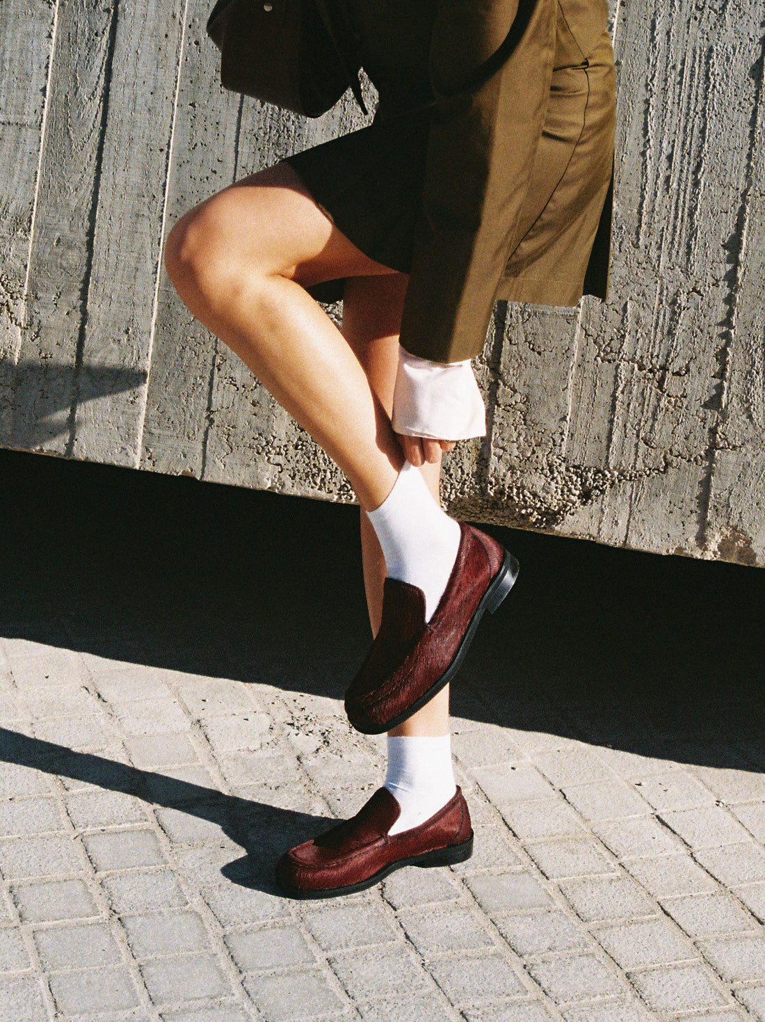 Dannie Bordeaux Hairy Leather Loafers paired with white socks and a tailored olive green blazer - Side View - POEVE Collection