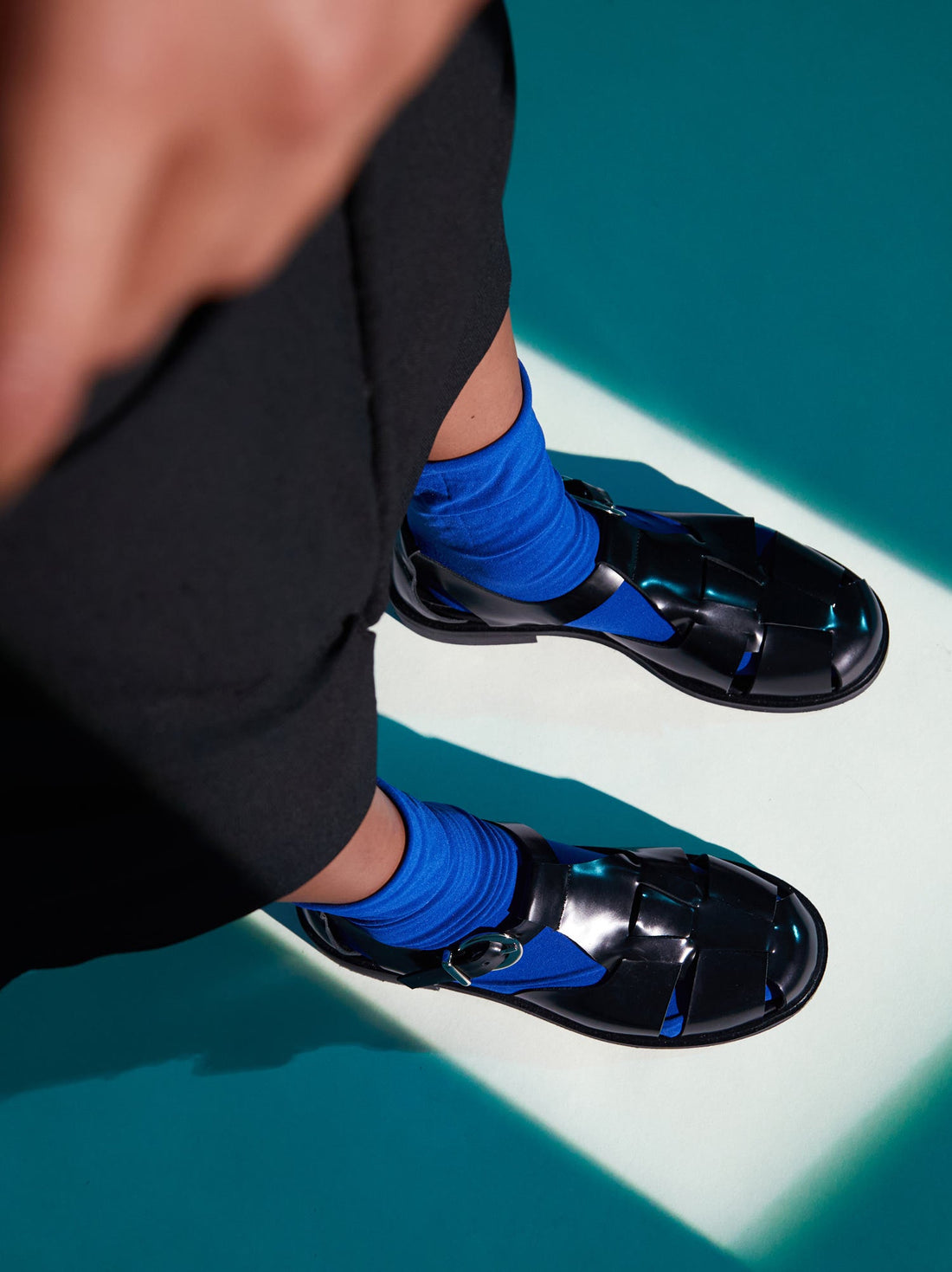 Raven Black Brushed Leather Fisherman Sandals, styled with vibrant cobalt blue socks - POEVE Collection