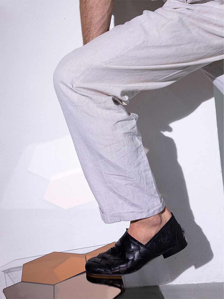 Sand Black Hand-Woven Leather Loafers, styled with off-white relaxed linen trousers - POEVE Collection