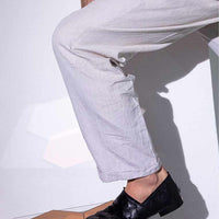 Sand Black Hand-Woven Leather Loafers, styled with off-white relaxed linen trousers - POEVE Collection